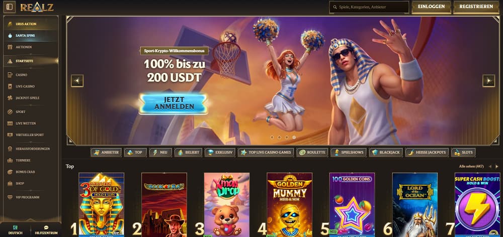 Realz Casino-Startseite mit einem lebhaften Banner mit Cheerleader und ägyptisch gekleidetem Charakter, der einen 100 % Sport-Krypto-Bonus bis zu 200 USDT bewirbt. Die dunkle Oberfläche bietet Navigation für Casino, Live-Spiele, Sportwetten, Jackpots und Top-Slots wie Golden Mummy – Hold & Win und Lucky Joker 100.